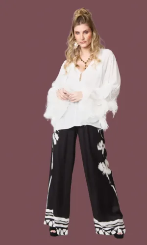 Blusa blanca con plumas y pantalón palazzo estampado